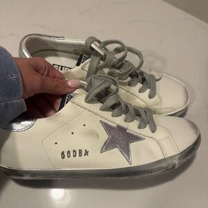 Golden Goose White and Silver Star Sneakers fits a US size 9
